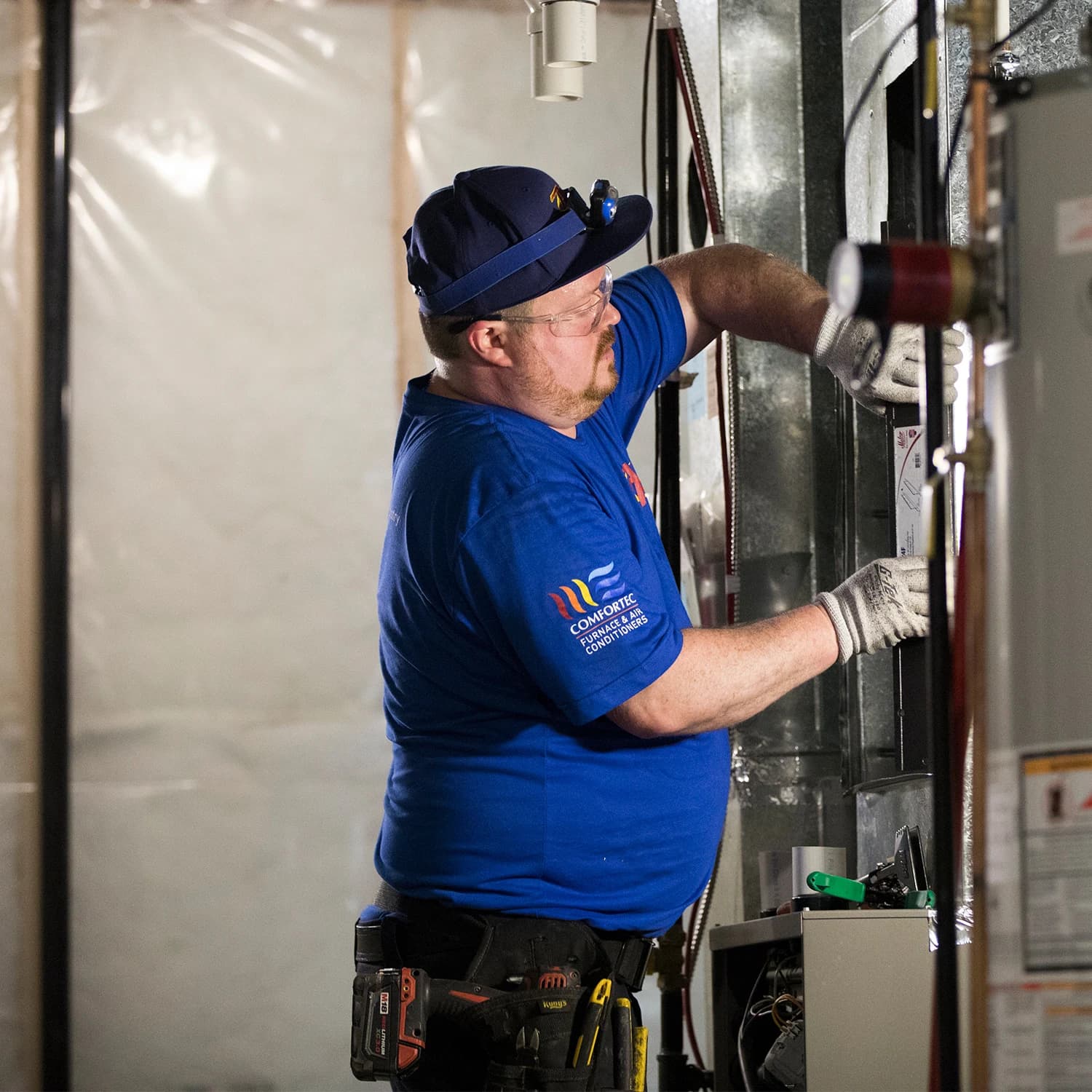 Action Furnace technician inspecting a residential furnace